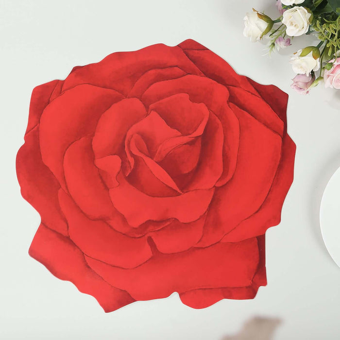 Red rose centerpiece on a table with flowers in the background.