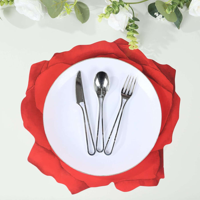 Elegant table setting with silverware on a red rose placemat.