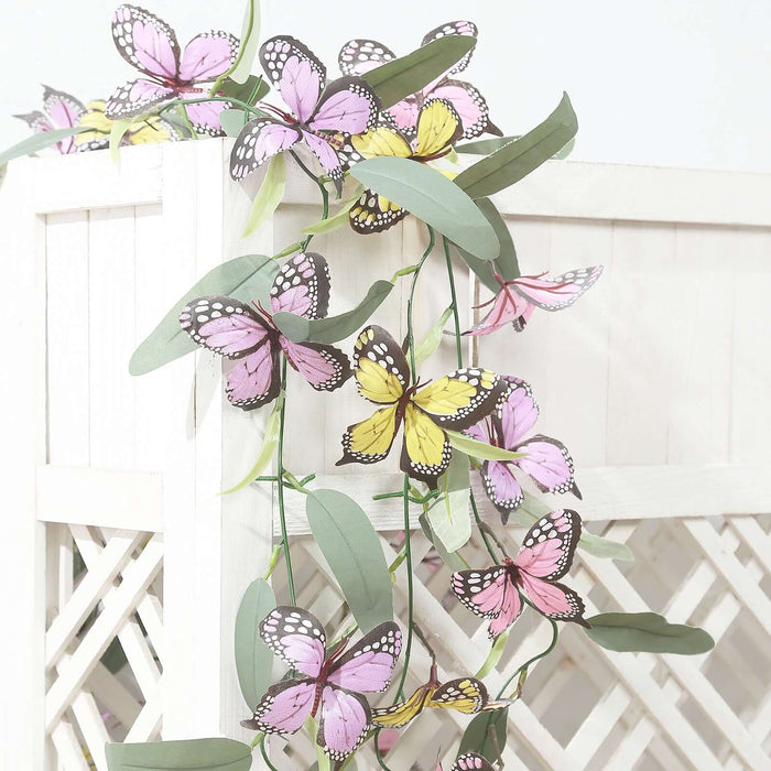 Colorful butterfly garland with pink and yellow butterflies on green leaves.