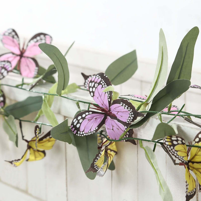 Colorful butterfly garland decoration with green leaves.