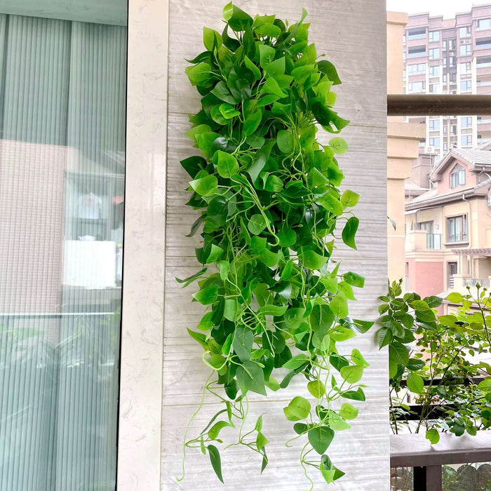 Artificial green hanging plant decor for home or office.