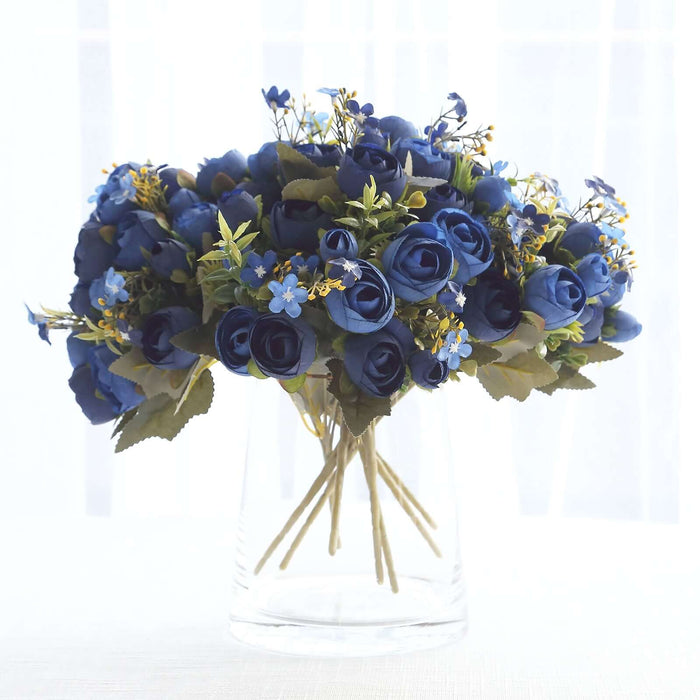 Blue rose bouquet in a clear glass vase.
