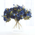 Blue rose bouquet in a clear glass vase.