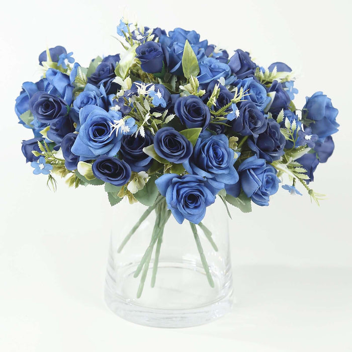 Blue rose bouquet in a clear vase on a plain background