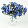 Blue rose bouquet in a clear vase on a plain background