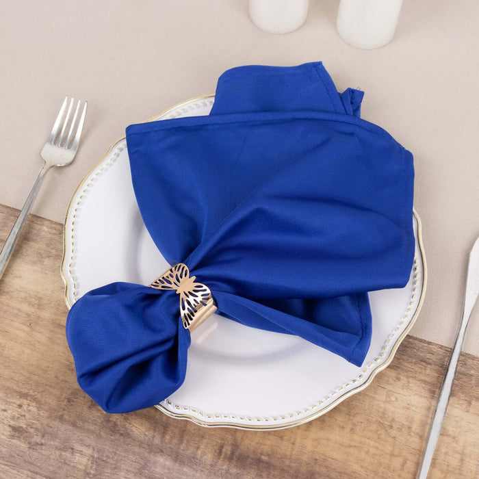 Blue napkin elegantly styled on a white plate with a decorative napkin ring.