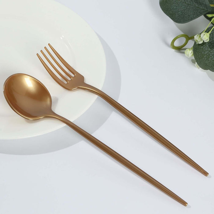 Gold cutlery set with spoon, fork, and chopsticks on white plate
