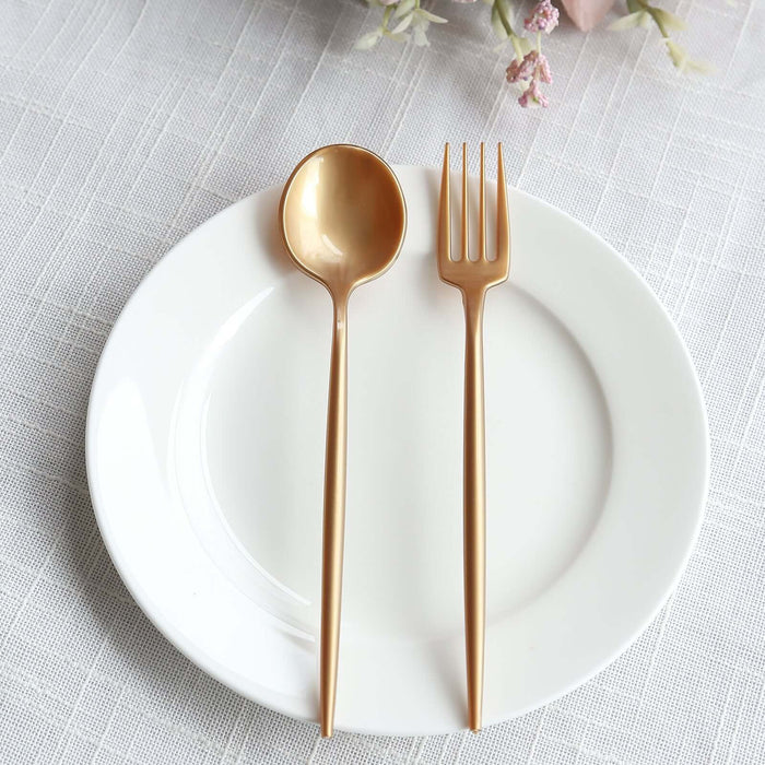 Gold spoon and fork on a white plate