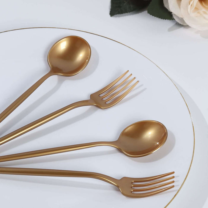 Gold cutlery set featuring forks and spoons on a white plate.