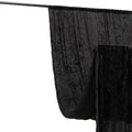 Black velvet backdrop draped on a support stand for photography.