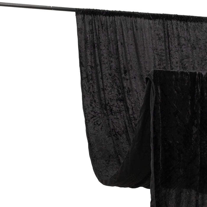 Black velvet backdrop draped on a support stand for photography.