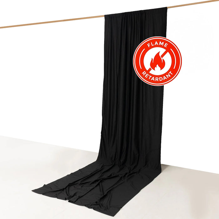 Black flame-retardant fabric drape hanging from a rod