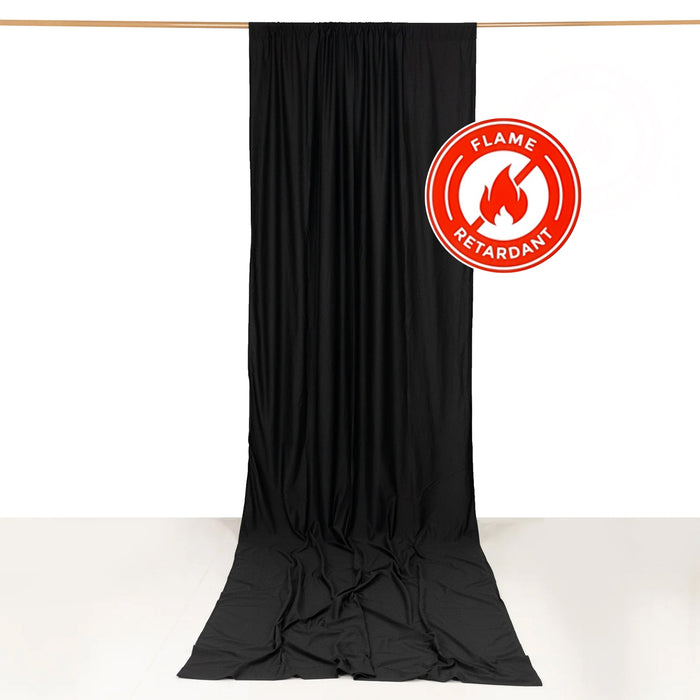 Black flame-retardant fabric backdrop hanging from a wooden rod