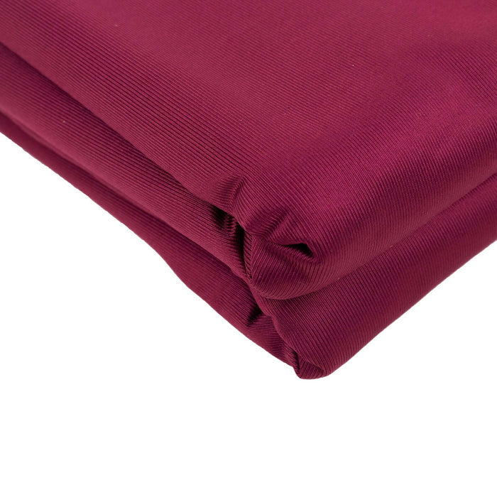 Burgundy fabric roll with smooth texture and rich color