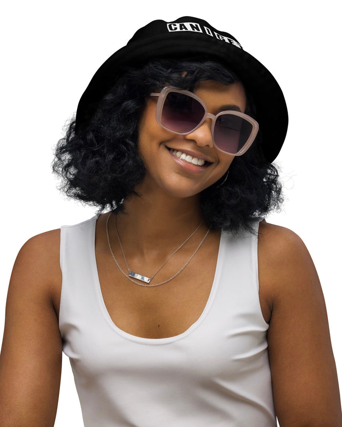 Model wearing a black bucket hat with the phrase "CAN I GET A BUMP?".