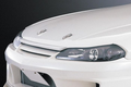 DO-LUCK Bonnet Lip for Nissan Silvia S15 in white polyurethane, enhancing front-end aerodynamics and JDM styling for performance vehicles.