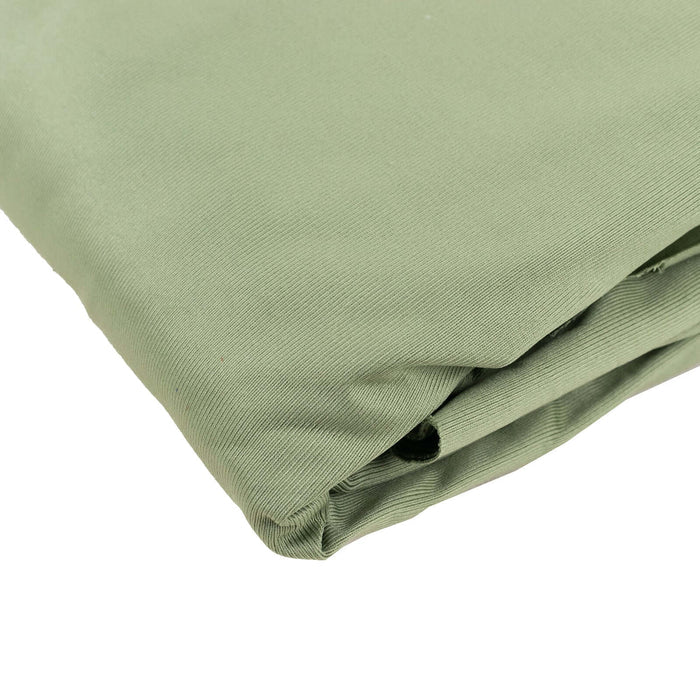 Green fabric folded neatly on a white background.
