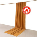 Flame-retardant fabric curtain in warm golden color against a plain backdrop