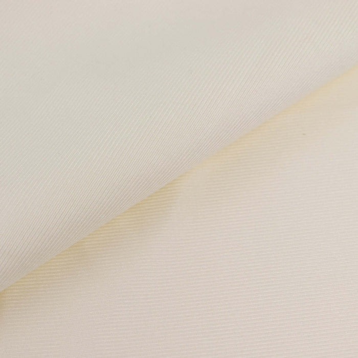 Textured cream fabric showcasing subtle lines and folds.
