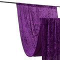 Purple velvet fabric draped on a rod in a studio setting.