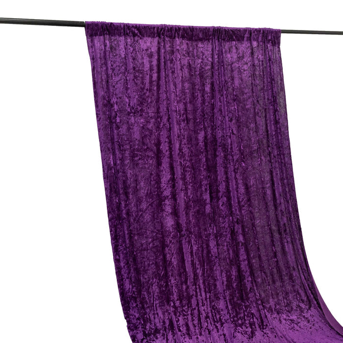 Purple velvet fabric draped on a black rod against a white background