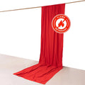 Red flame-retardant fabric drape on a white backdrop.