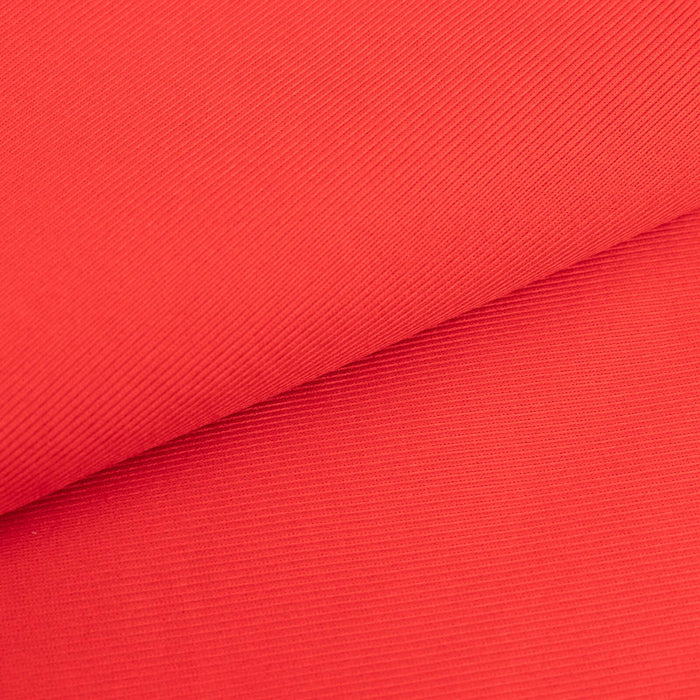 Red ribbed fabric showcasing texture and color detail.