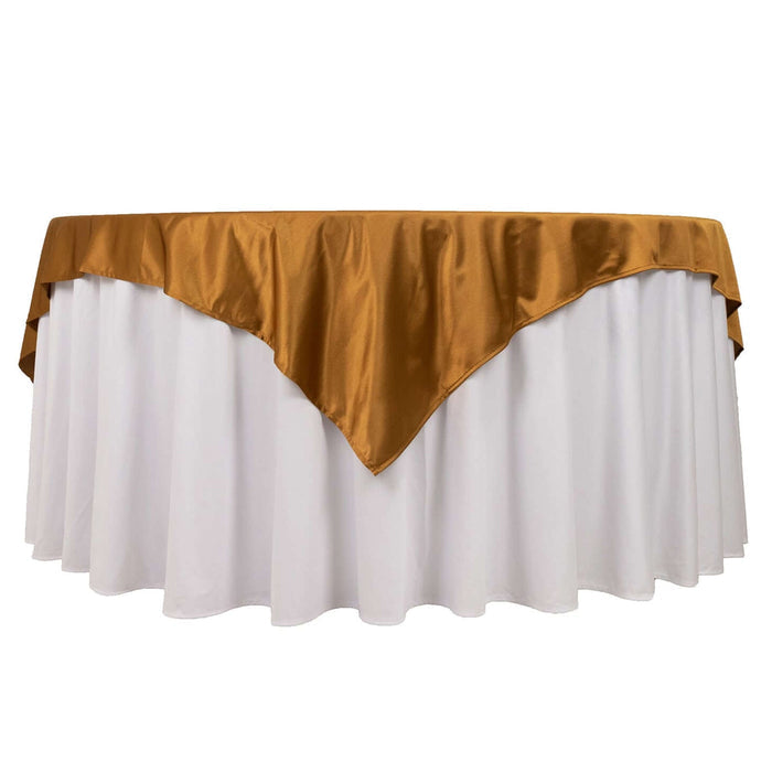 White tablecloth with gold satin overlay for elegant events