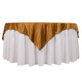White tablecloth with gold satin overlay for elegant events