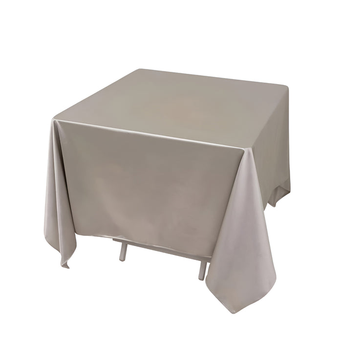 Gray tablecloth draped over a square table on a white background