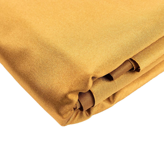 Gold fabric roll for sewing projects, showcasing smooth texture and vibrant color.