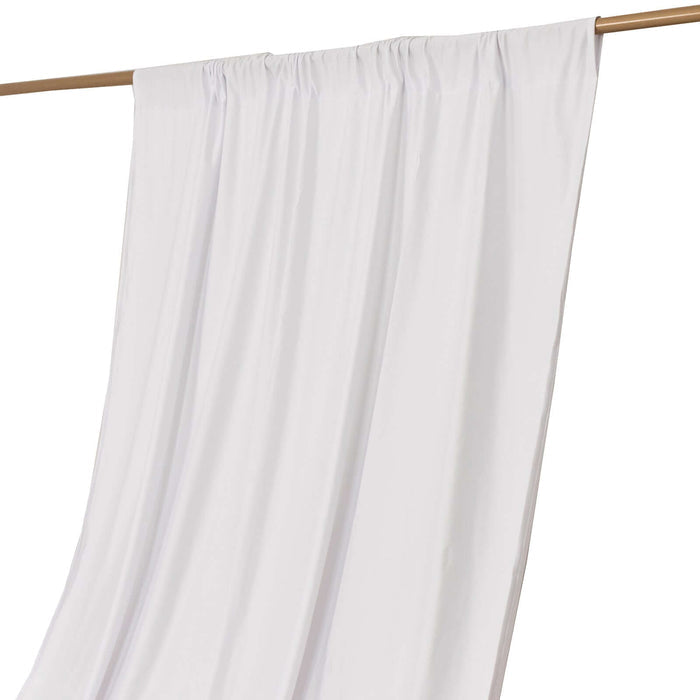 White curtain draped on a wooden rod for elegant home decor.